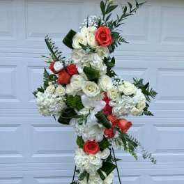 Cross-shaped floral standing spray with white and coral roses