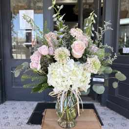 Pink roses and white hydrangeas in a glass vase