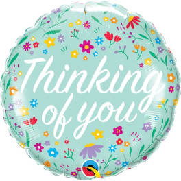 Round mint-green balloon with floral print and the words "Thinking of you"