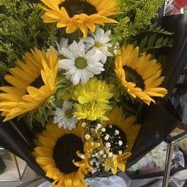 Bouquet of sunflowers and white daisies wrapped in black paper