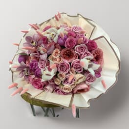 Pink and lavender rose bouquet wrapped in cream paper