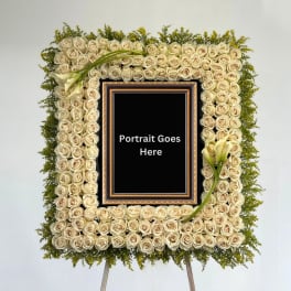 Square floral frame of cream roses with calla lilies around a portrait opening