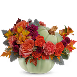 Pumpkin-shaped vase with orange and purple flowers