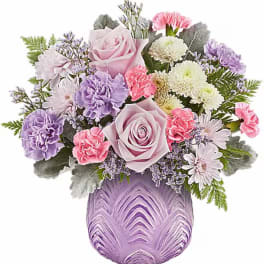 Lavender and pink bouquet in a purple glass vase