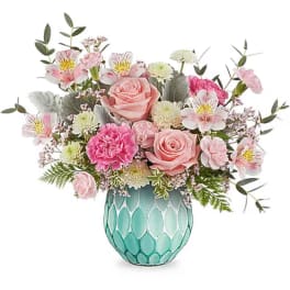 Pink and white mixed flower arrangement in a turquoise vase