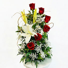 Tall arrangement of red roses and white lilies with baby's breath