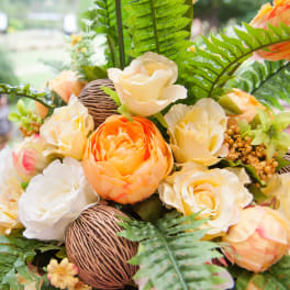 Bouquet of cream and orange roses with fern leaves