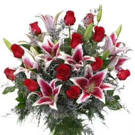 Bouquet of red roses and pink lilies in a glass vase