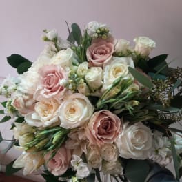 Bouquet of blush and white roses with greenery