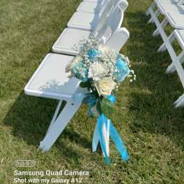 White chair decorated with a blue and white floral bouquet