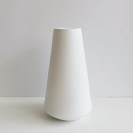 Tall white ceramic vase on a plain background