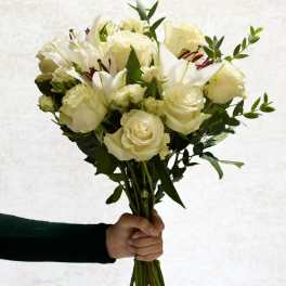 Handheld bouquet of white roses and lilies
