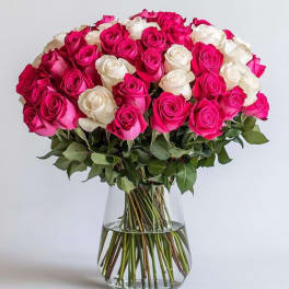 Bouquet of pink and white roses in a clear glass vase