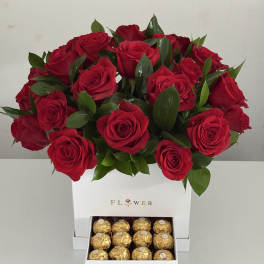 Red rose arrangement in a white box with a drawer of gold chocolates