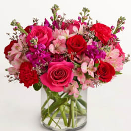 Pink and red rose bouquet in a clear glass vase