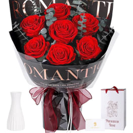 Bouquet of red roses wrapped in black paper with a ribbon bow