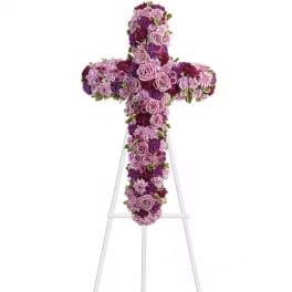 Purple and pink floral cross on a clear stand
