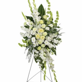 Tall white and pale green floral standing spray on an easel
