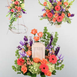 Bright floral arrangement with orange roses, pink gerberas, and purple blooms
