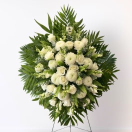 White floral standing spray with roses and mums on an easel
