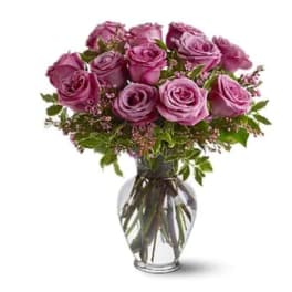 Bouquet of purple roses in a clear glass vase