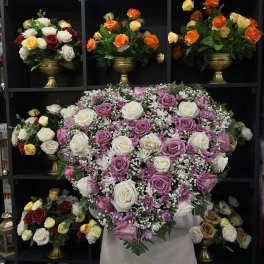 Large bouquet of pink and white roses with purple daisies