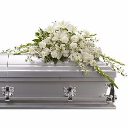White floral spray on a silver casket