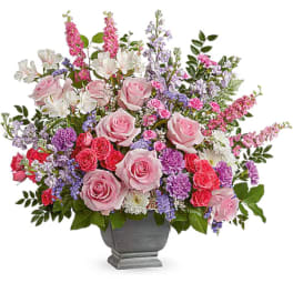 Pink and purple mixed flower arrangement in a gray urn vase