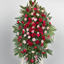 Large standing floral spray with red roses and pink carnations