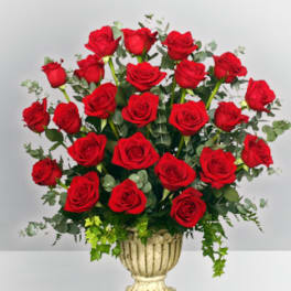 Red roses arranged in a decorative urn vase