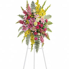 Tall floral spray with pink, yellow, and white blooms on a stand