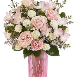 Pink and white mixed bouquet in a tall pink vase