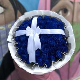 Bouquet of deep blue roses wrapped with white ribbon
