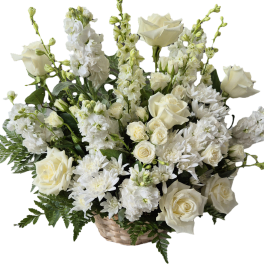 White roses and chrysanthemums arranged in a basket