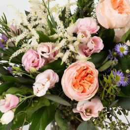 Bouquet of blush and peach flowers with purple accents