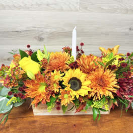 Autumn floral centerpiece with a white taper candle