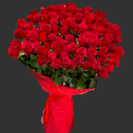 Large bouquet of red roses wrapped in red paper