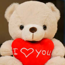 White teddy bear holding a red heart with "I love you" text