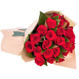 Bouquet of red roses wrapped in tan paper
