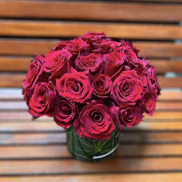 Bouquet of deep pink roses in a glass vase