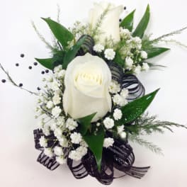 White rose arrangement with baby's breath and black ribbon on a white background