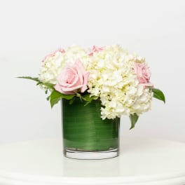 Pink roses and white hydrangeas in a glass vase