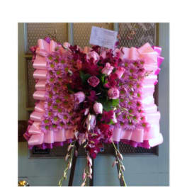 Pink and magenta floral standing spray with ribbon trim
