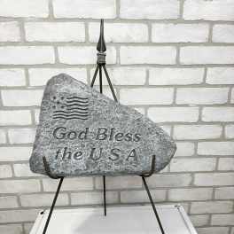 Stone memorial plaque on a metal stand with engraved text
