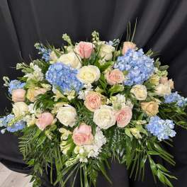Large bouquet of pink and white roses with blue hydrangeas