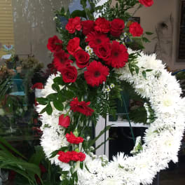 Red and white funeral standing spray on an easel