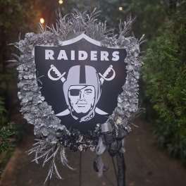 Raiders memorial wreath with silver flowers and ribbon