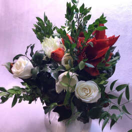 White and red roses arranged in a clear glass vase