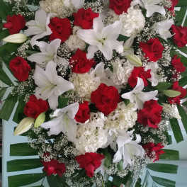 Large standing spray of red roses, white lilies, and white hydrangeas