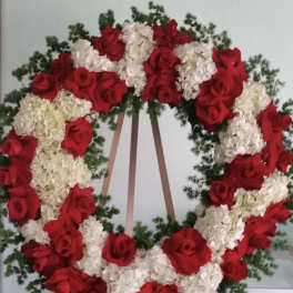 Large wreath of red roses and white hydrangeas on an easel
